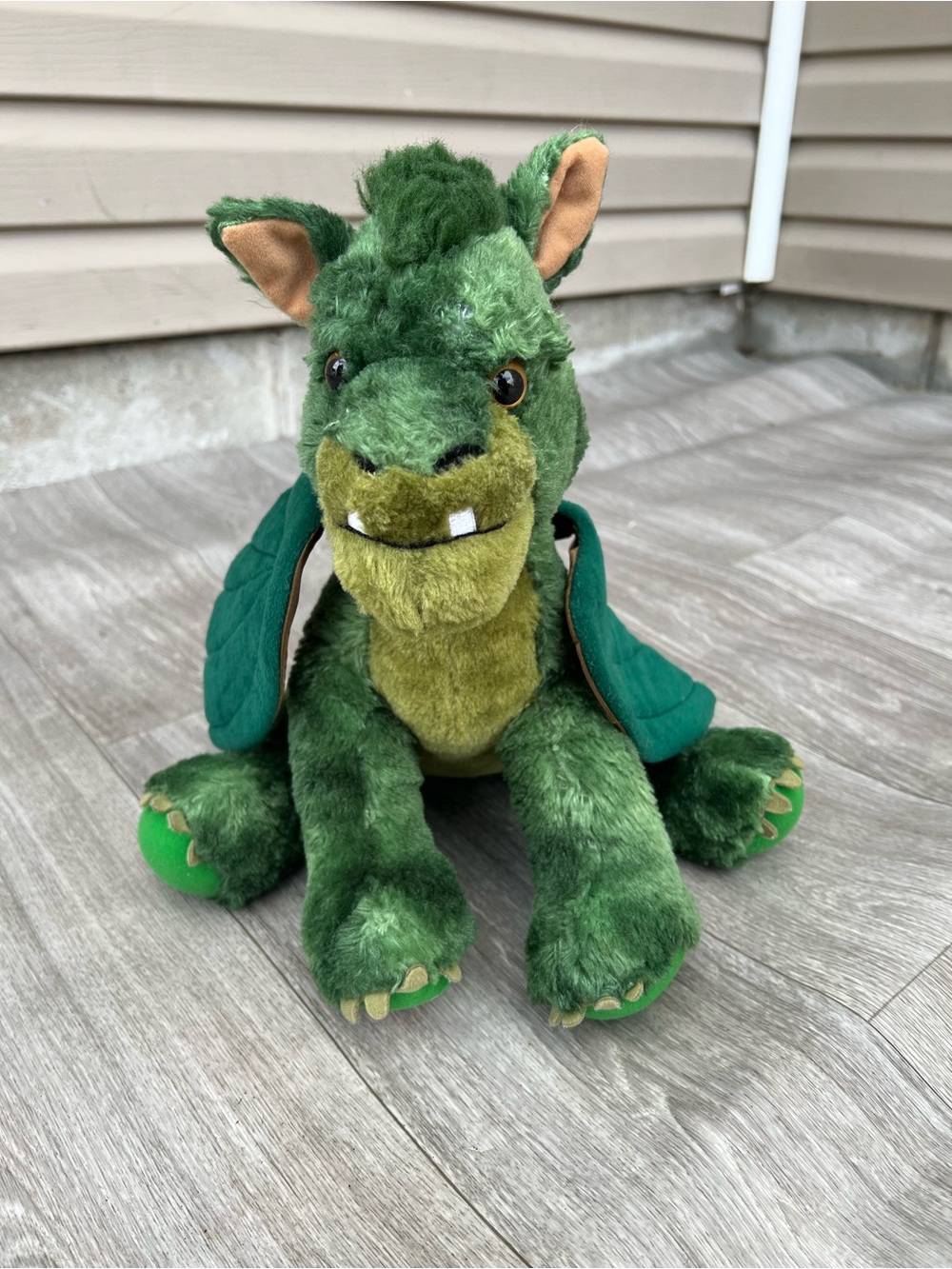 Elliot from the Disney movie "Pete's Dragon." 
Brand: Build-A-Bear Workshop